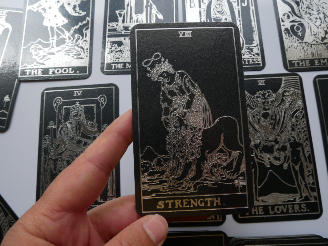Black tarot deck with silver foil-pressed Waite-Smith design.